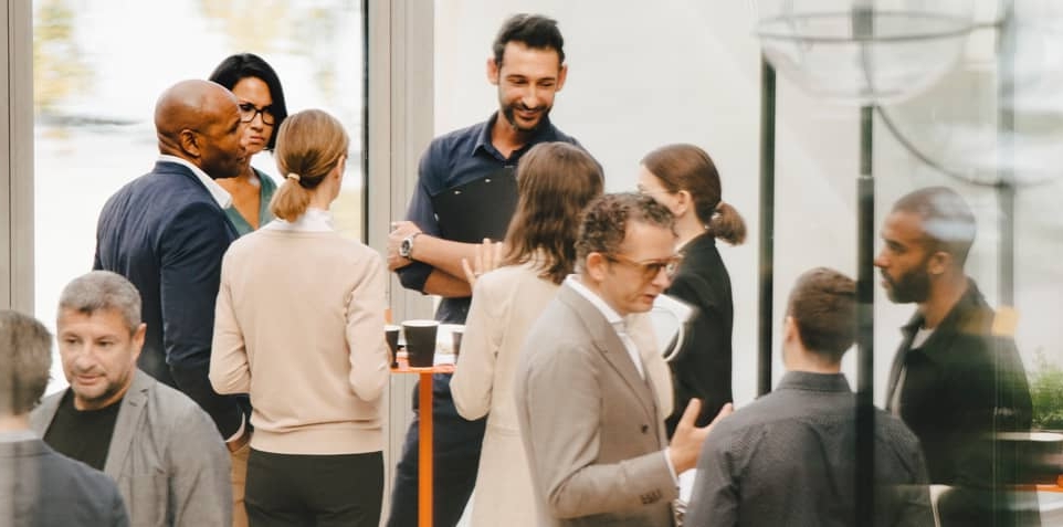 A diverse group of people at a corporate social event